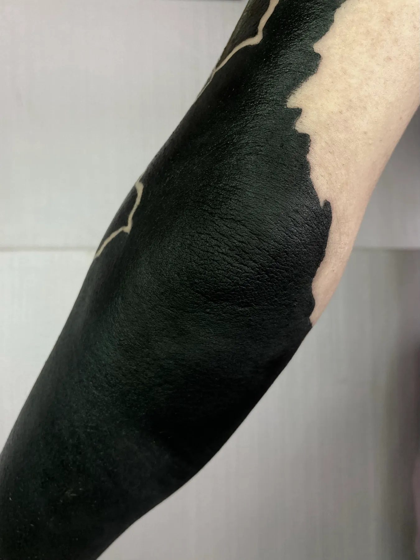 Lava Elbow — Blackout tattoo by Nillattt, photo 1